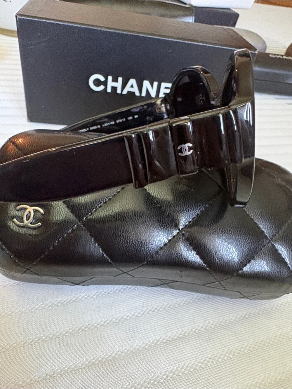 CHANEL Black Oversized Round Women's Sunglasses with iconic bows on each side.